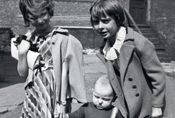 Pat, Paul, Jr. and Joanne Angell between coach house and main house at 2626 S. Michigan Ave., Chicago circa 1940.