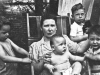 Charles, Gwen holding Bob, Paul and Tom in back of house at 5604 S. Dorchester, Chicago 1944