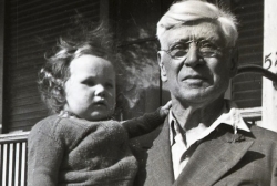 Grandpa Merton Angell, holding Jonia Thelin, in front of his house in Grand Rapids, Michigan 1943